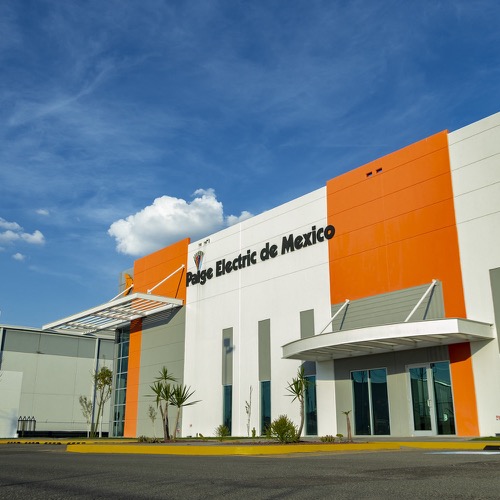The front of 'Paige Electric de Mexico', A white and orange building.